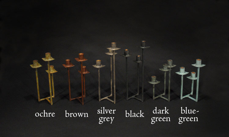 six colors of patinaed brass rod triple candelabra with color names